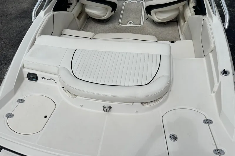 Slide: The Image of 2008 Monterey 194FS boat interior with white seating and storage compartments. - 9