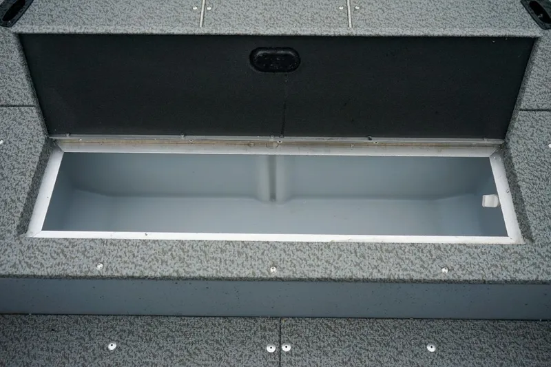 Slide: The Image of Open storage compartment in 2026 Lund 1400 Fury Tiller boat, showcasing interior space. - 13