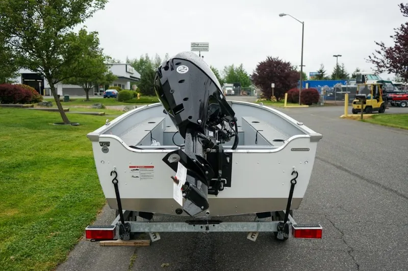 Slide: The Image of 2026 Lund 1400 Fury Tiller boat on trailer, parked outdoors. - 8