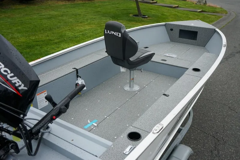 Slide: The Image of 2026 Lund 1400 Fury Tiller boat with Mercury engine, featuring spacious interior and single seat. - 9