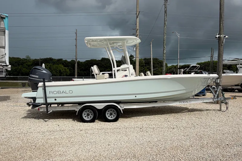 The Image of 2017 Robalo 246 Cayman boat on trailer with Yamaha engine, parked outdoors. - 0