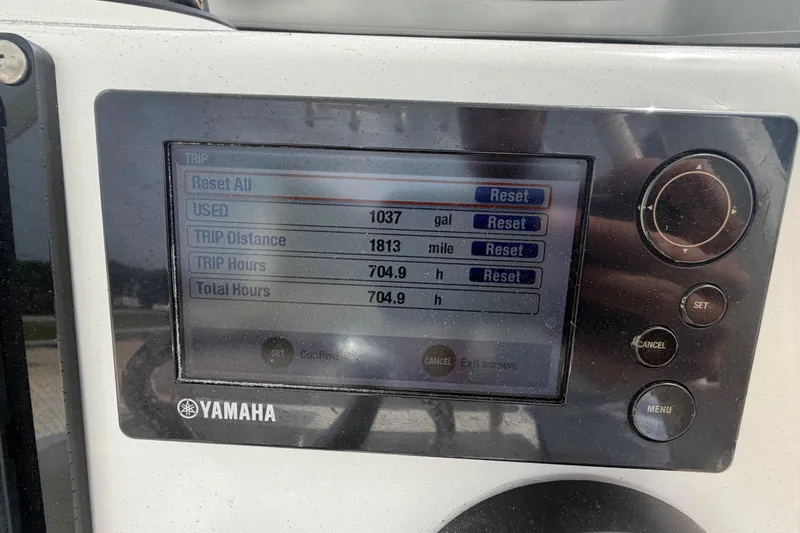 Slide: The Image of Yamaha display showing trip data: 1037 gallons used, 1813 miles, 704.9 hours on Robalo 246 Cayman. - 10