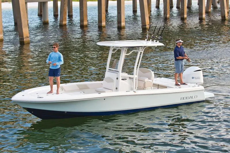 Slide: The Image of Manufacturer Provided Image: 2017 Robalo 246 Cayman boat with two people fishing near a pier. - 11