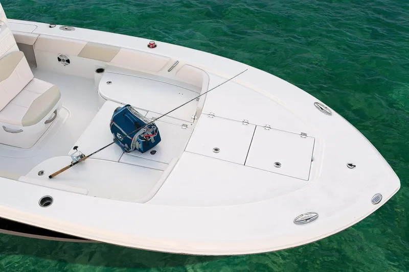 Slide: The Image of Manufacturer Provided Image: 2017 Robalo 246 Cayman boat deck with fishing gear on clear water. - 14