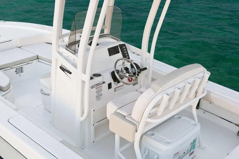 Slide: The Image of Manufacturer Provided Image: 2017 Robalo 246 Cayman boat console and seating area on calm water. - 19