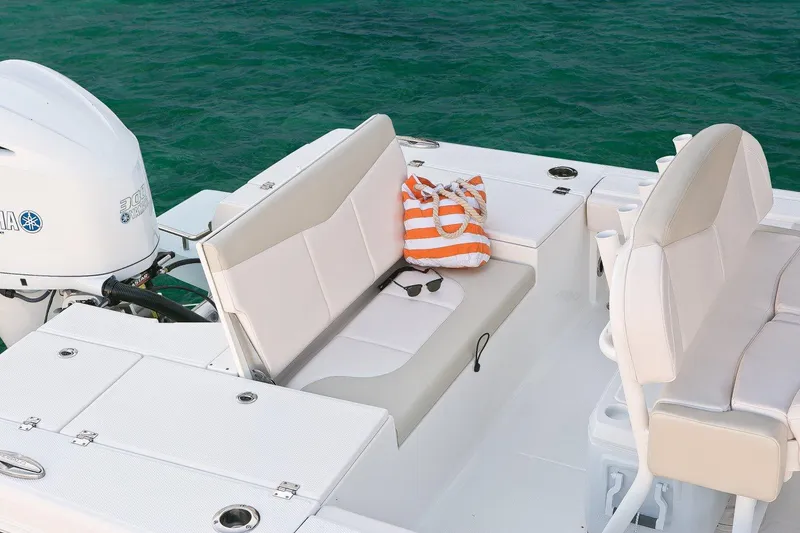 Slide: The Image of Manufacturer Provided Image: 2017 Robalo 246 Cayman boat interior with seating and striped bag. - 22