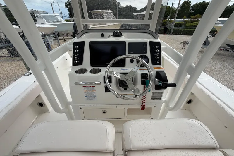 Slide: The Image of 2017 Robalo 246 Cayman boat console with steering wheel and navigation controls. - 4