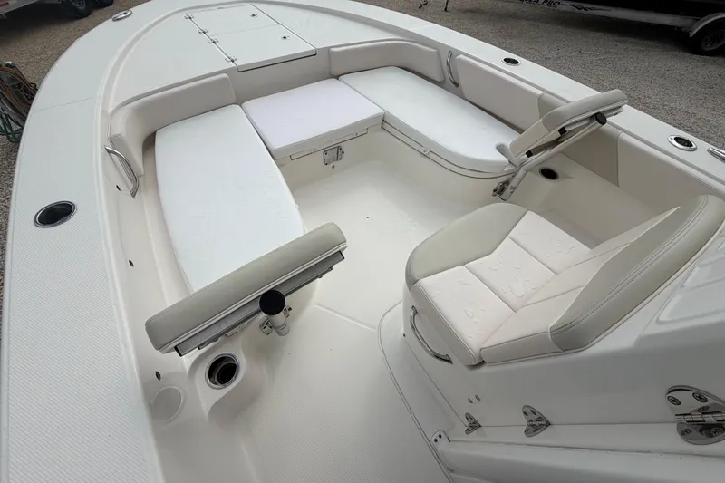 Slide: The Image of 2017 Robalo 246 Cayman boat interior with cushioned seating and storage compartments. - 5