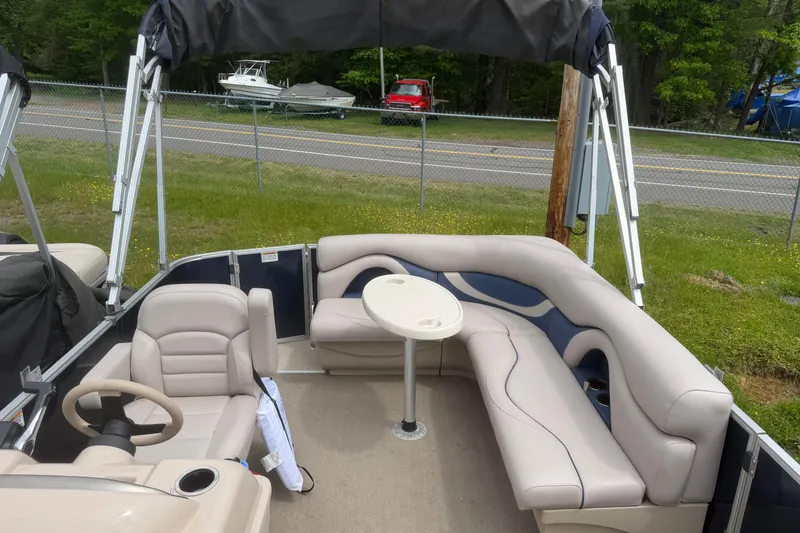 Slide: The Image of 2014 Sylvan Mirage Cruise 818 CR pontoon boat interior with seating and table. - 10