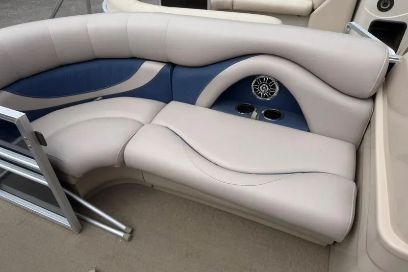 Slide: The Image of 2014 Sylvan Mirage Cruise 818 CR boat interior with plush seating and cup holders. - 5