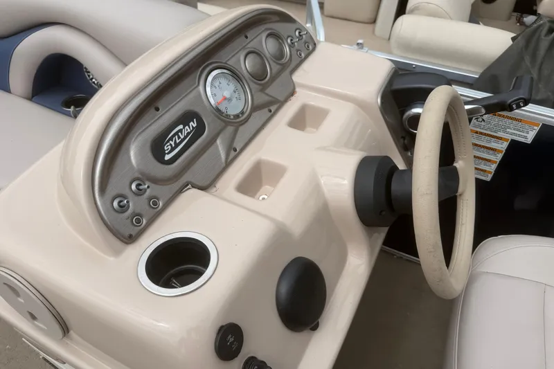 Slide: The Image of 2014 Sylvan Mirage Cruise 818 CR dashboard with steering wheel and controls. - 6
