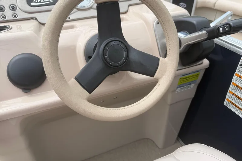 Slide: The Image of Steering wheel of 2014 Sylvan Mirage Cruise 818 CR boat, featuring control panel and throttle. - 7