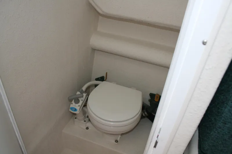 Slide: The Image of Compact marine toilet in 2002 Sea Sport Explorer 2400 boat interior. - 11