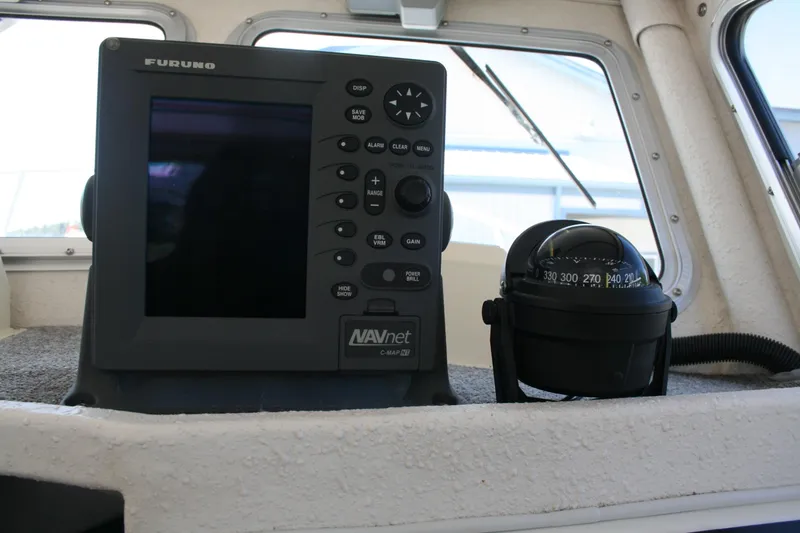 Slide: The Image of Navigation equipment inside a 2002 Sea Sport Explorer 2400 boat cockpit. - 5