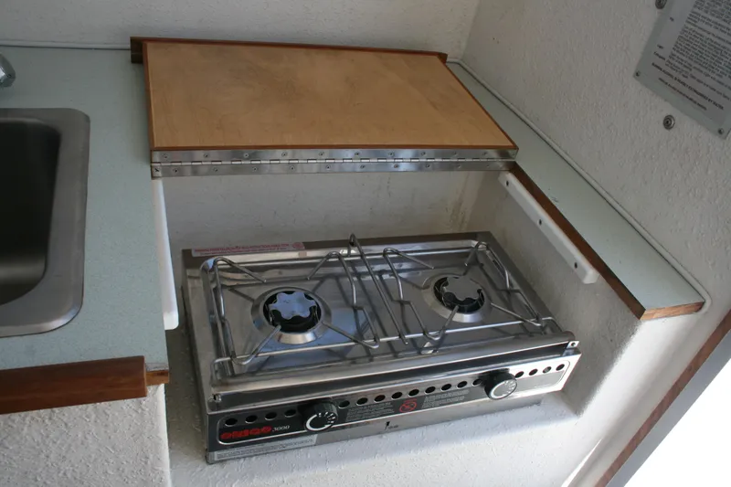 Slide: The Image of Two-burner stove in 2002 Sea Sport Explorer 2400 boat kitchen area. - 9