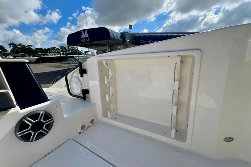 Slide: The Image of 2026 Navan S30 boat interior with storage compartment and speaker, under a cloudy sky. - 15