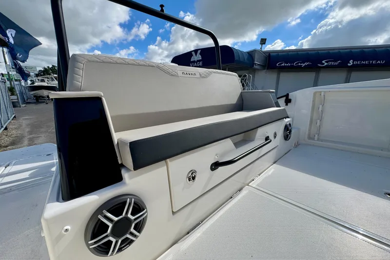Slide: The Image of 2026 Navan S30 boat interior with cushioned seating and speaker, under a partly cloudy sky. - 16