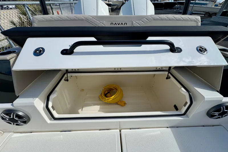 Slide: The Image of Open storage compartment on 2026 Navan S30 boat with yellow cable inside. - 17