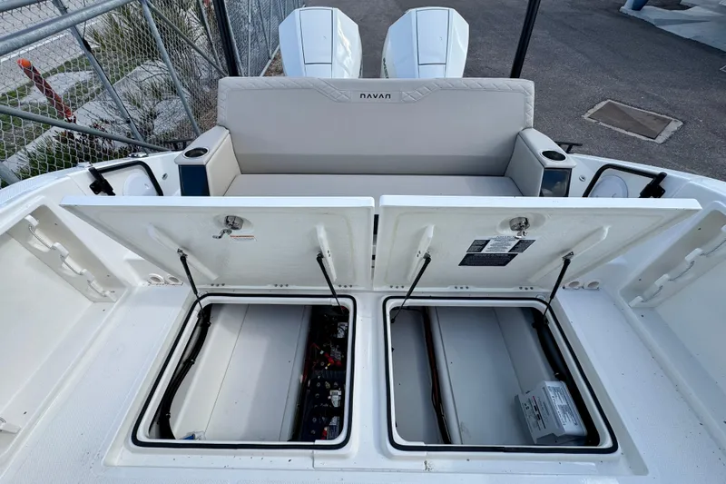 Slide: The Image of Navan S30 2026 boat with open storage compartments and dual engines at dock. - 18