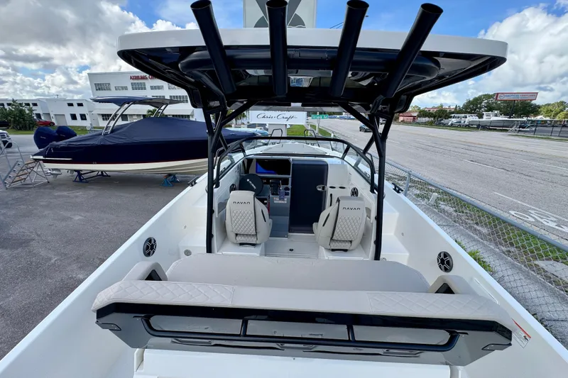 Slide: The Image of 2026 Navan S30 boat interior with modern seating and control panel, parked outdoors. - 26