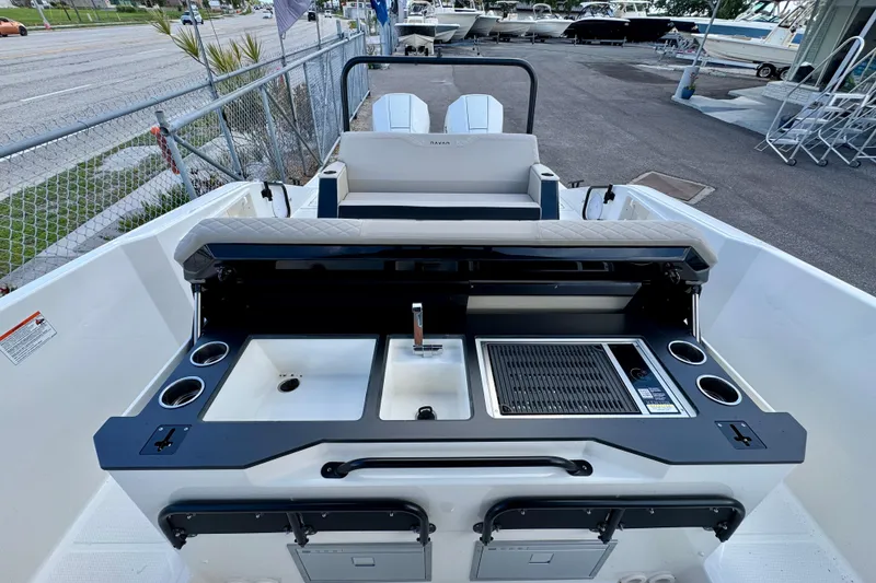Slide: The Image of 2026 Navan S30 boat with outdoor kitchen, featuring sink and grill, docked at marina. - 29