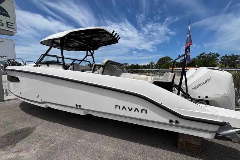 Slide: The Image of 2026 Navan S30 boat with Mercury engine, parked outdoors under a clear blue sky. - 3