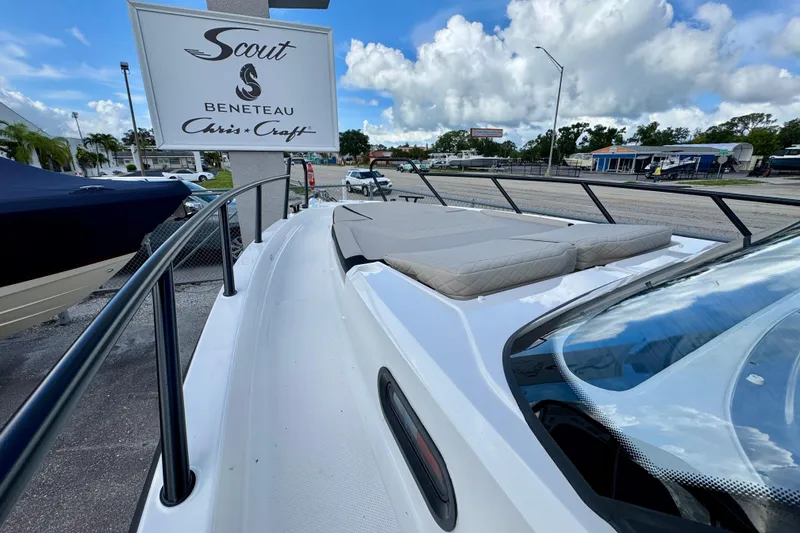 Slide: The Image of 2026 Navan S30 boat with cushioned deck, parked near dealership sign under blue sky. - 56