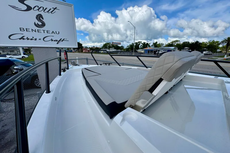 Slide: The Image of 2026 Navan S30 boat with cushioned seating, displayed near Scout and Beneteau signage. - 58