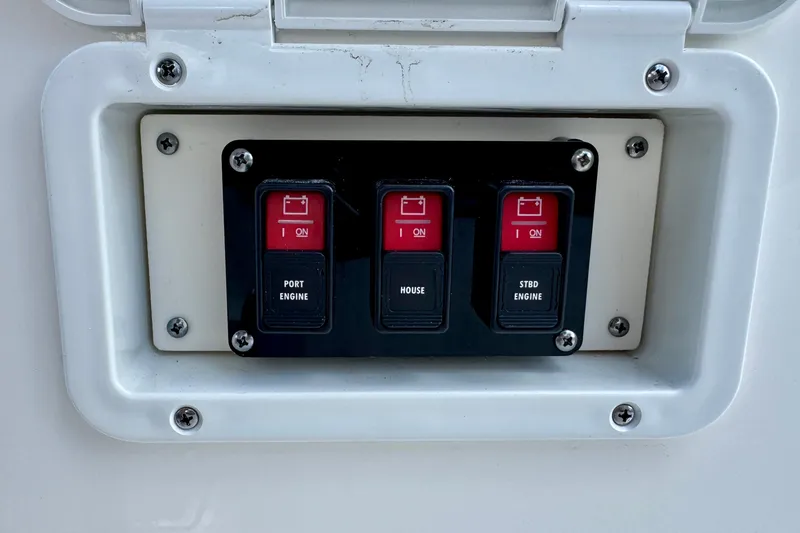 Slide: The Image of Control panel with switches for Navan S30, 2026 model, featuring port, house, and starboard engine. - 64