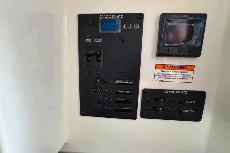 Slide: The Image of Electrical control panel in a 2026 Navan S30, featuring switches and warning label. - 65