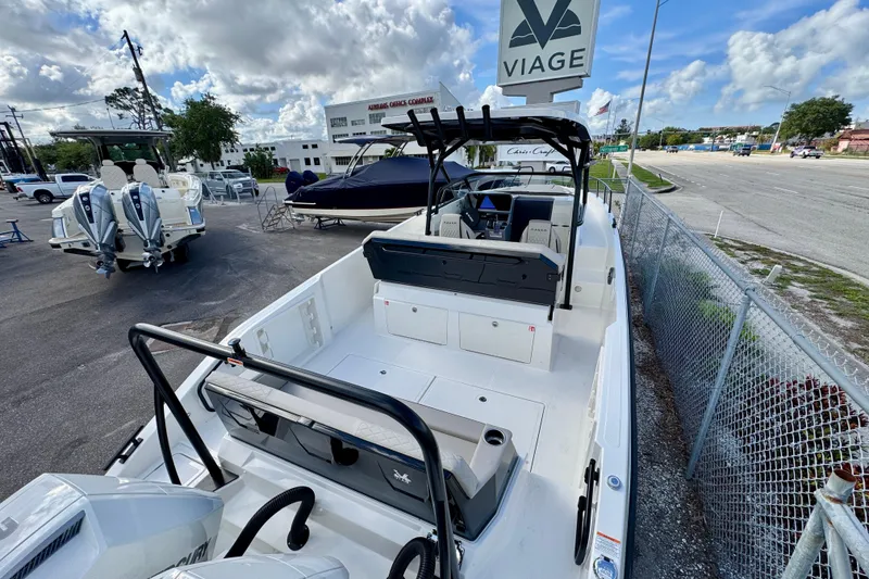 Slide: The Image of 2026 Navan S30 boat at a dealership, featuring sleek design and dual outboard motors. - 9