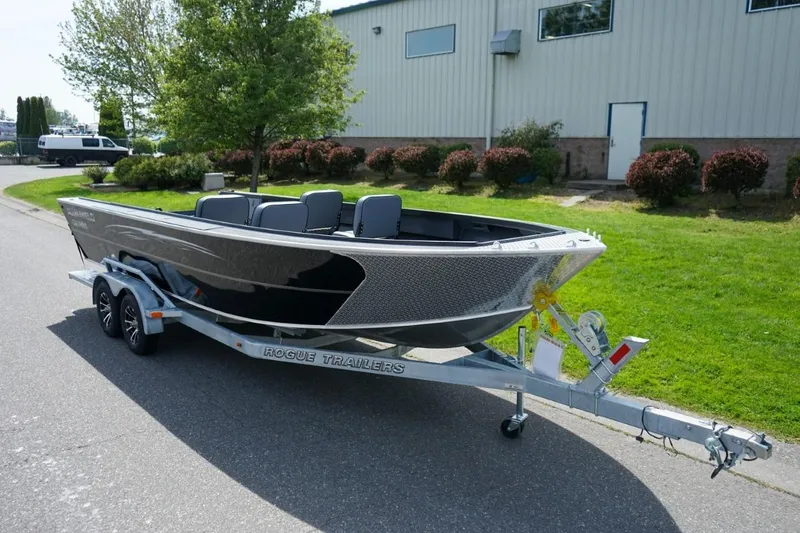 The Image of 2026 Alumaweld 23' Columbia boat on Rogue trailer, parked outdoors near a building. - 1