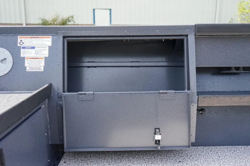 Slide: The Image of Open storage compartment on 2026 Alumaweld 23' Columbia boat, featuring a secure latch. - 12