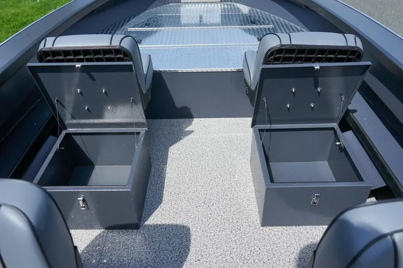 Slide: The Image of 2026 Alumaweld 23' Columbia boat interior with open storage compartments and seating. - 16