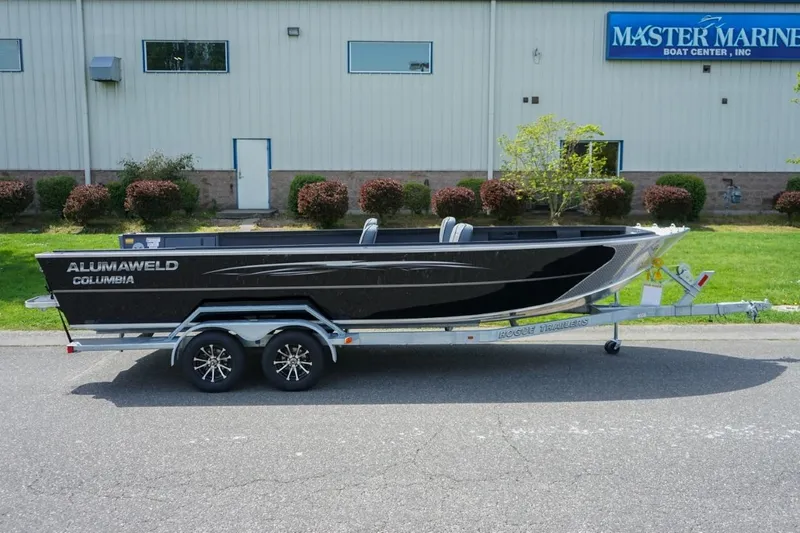 Slide: The Image of 2026 Alumaweld 23' Columbia boat on trailer outside Master Marine Boat Center. - 2