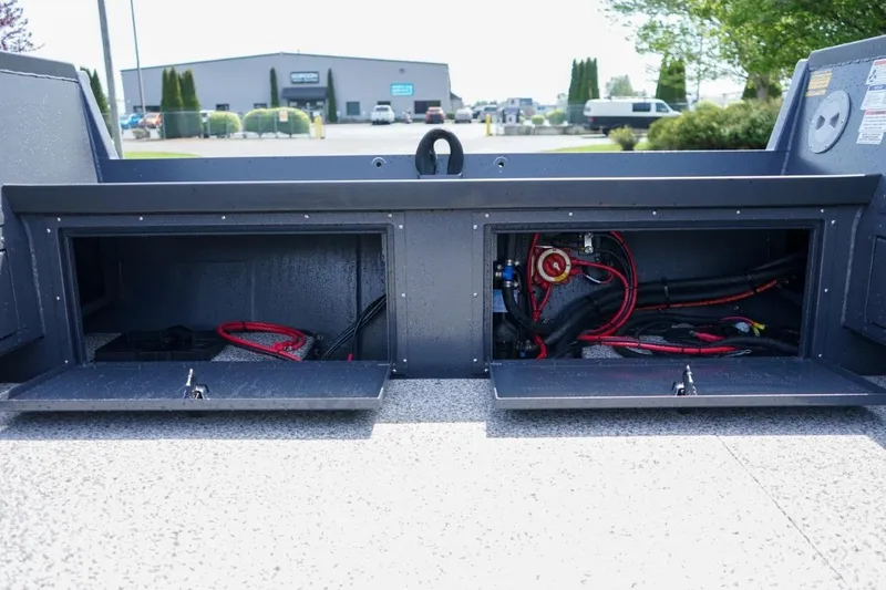 Slide: The Image of Open storage compartments with wiring in a 2026 Alumaweld 23' Columbia boat. - 7