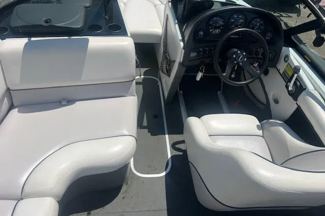 Slide: The Image of Interior of a 2000 Malibu Sunsetter VLX boat with white seating and dashboard. - 4