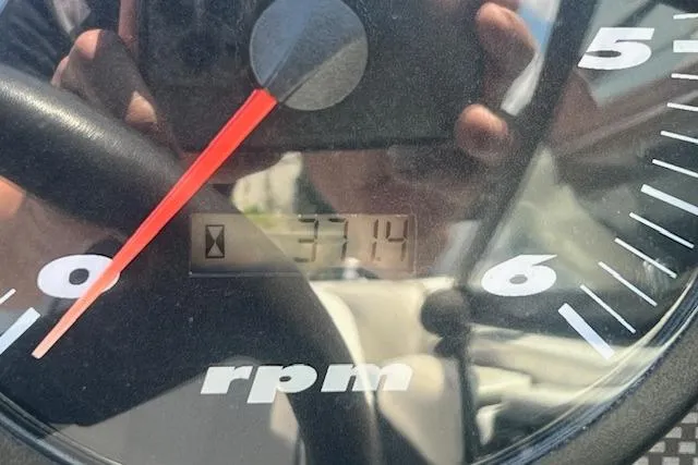 Slide: The Image of Close-up of a 2000 Malibu Sunsetter VLX tachometer showing 3714 RPM. - 5