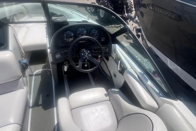 Slide: The Image of 2000 Malibu Sunsetter VLX boat interior with steering wheel and dashboard controls. - 6