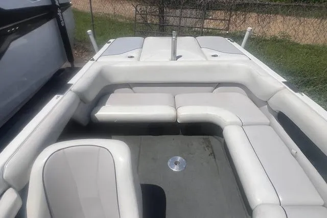 Slide: The Image of 2000 Malibu Sunsetter VLX boat interior with white seating and gray flooring. - 7