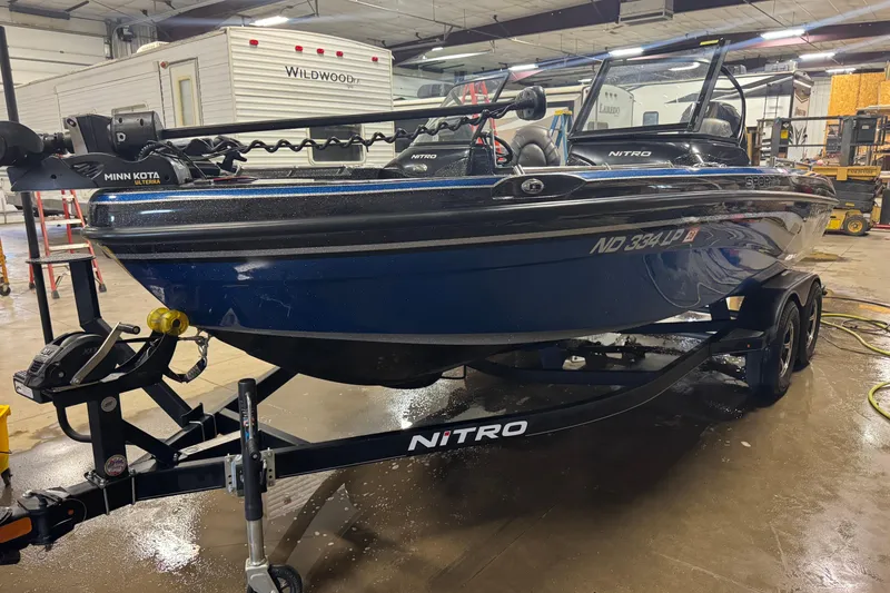 Slide: The Image of 2021 Nitro ZV19 Sport boat on trailer in indoor garage setting. - 1
