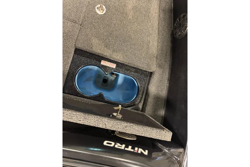 Slide: The Image of 2021 Nitro ZV19 Sport boat interior with storage compartment and blue insert. - 15