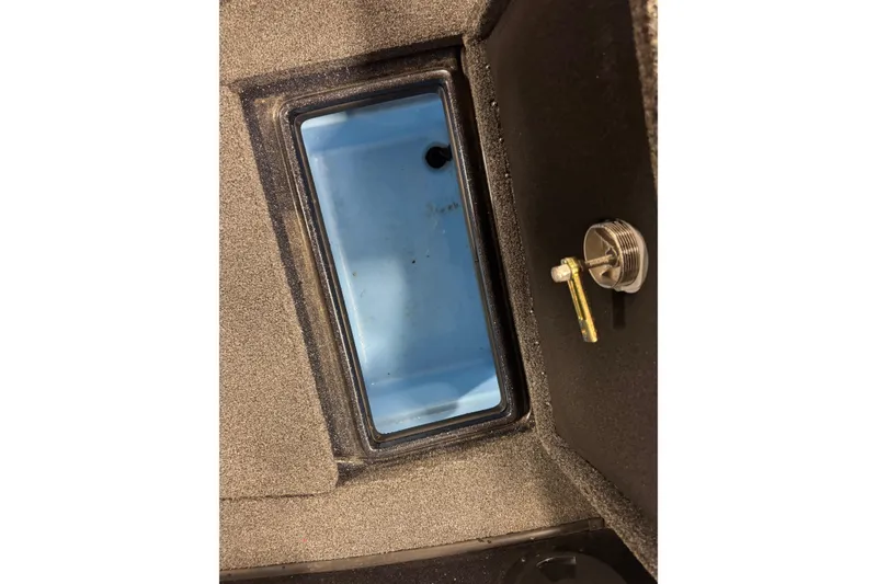 Slide: The Image of Interior compartment of 2021 Nitro ZV19 Sport boat, featuring a blue storage area. - 18