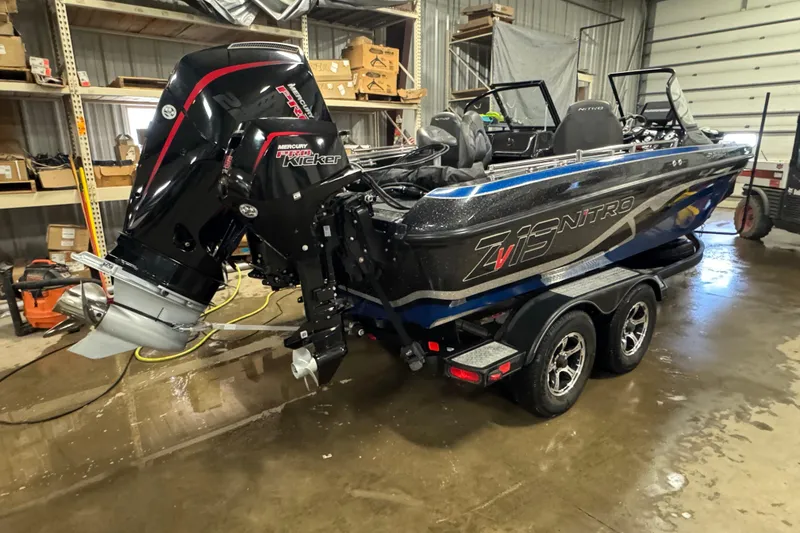 Slide: The Image of 2021 Nitro ZV19 Sport boat with Mercury Pro Kicker engine in a garage setting. - 3