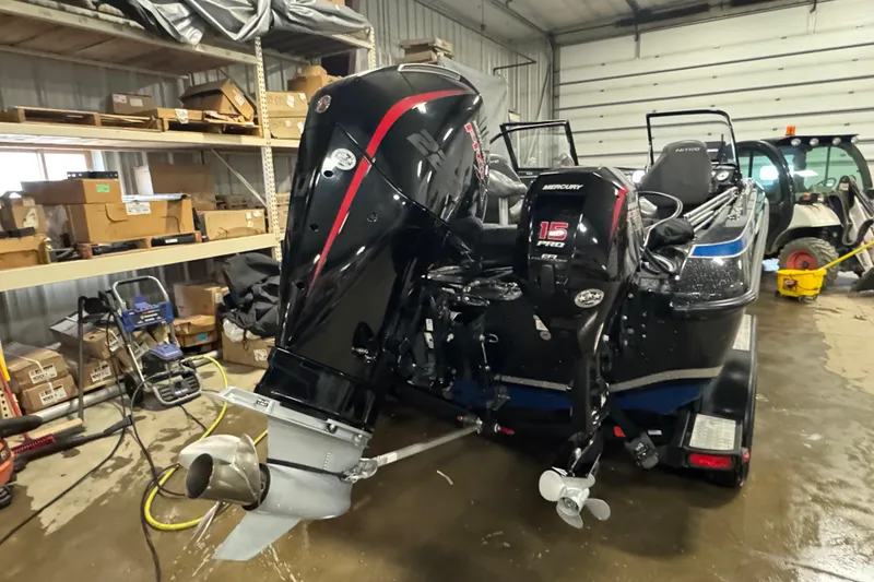 Slide: The Image of 2021 Nitro ZV19 Sport boat with dual Mercury outboard motors in a garage setting. - 5