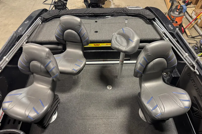 Slide: The Image of 2021 Nitro ZV19 Sport boat interior with four gray seats and carpeted flooring. - 9