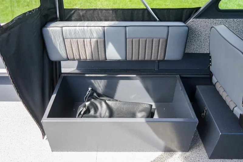 Slide: The Image of Interior storage compartment of 2026 Alumaweld X202 Stryker boat, featuring cushioned seating. - 14