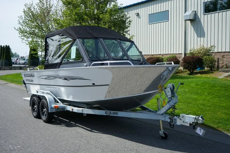 Slide: The Image of Interior of 2026 Alumaweld X202 Stryker boat, featuring steering wheel and seating. - 17