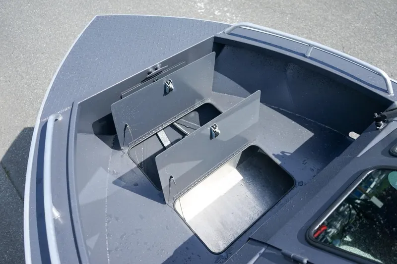 Slide: The Image of 2026 Alumaweld X202 Stryker boat storage compartments, open and empty, on a sunny day. - 20