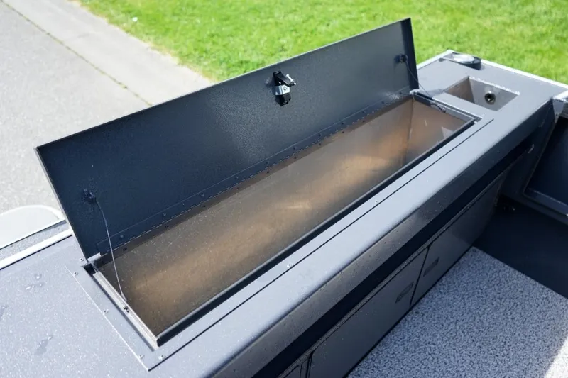 Slide: The Image of 2026 Alumaweld X202 Styker boat storage compartment open, showcasing interior space. - 9